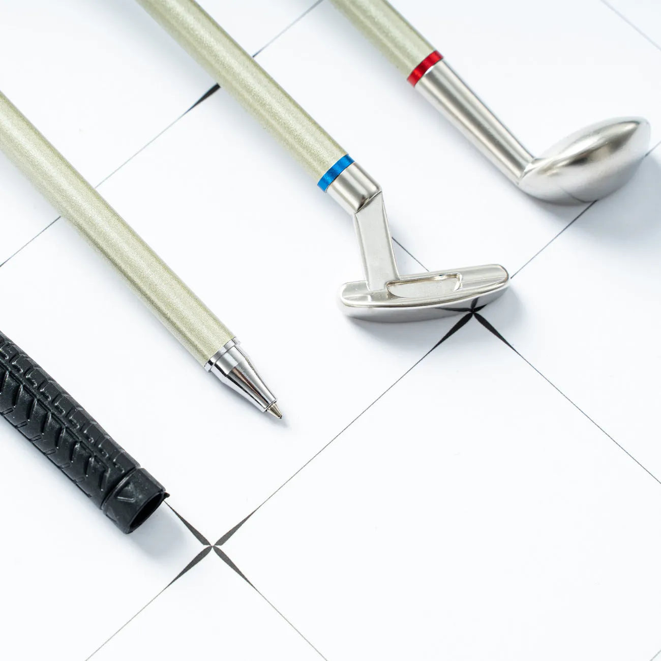 Three metal ballpoint pens with suit pattern design showing 0.7mm writing tips