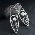 Silver lotus vine floral earrings with geometric elements and rhinestone accents