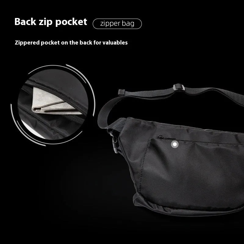 Black slanted chest bag with sewing line details, worn crossbody style
