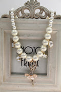 Children's Korean style pearl necklace in Symphony Pink, laid flat on white background