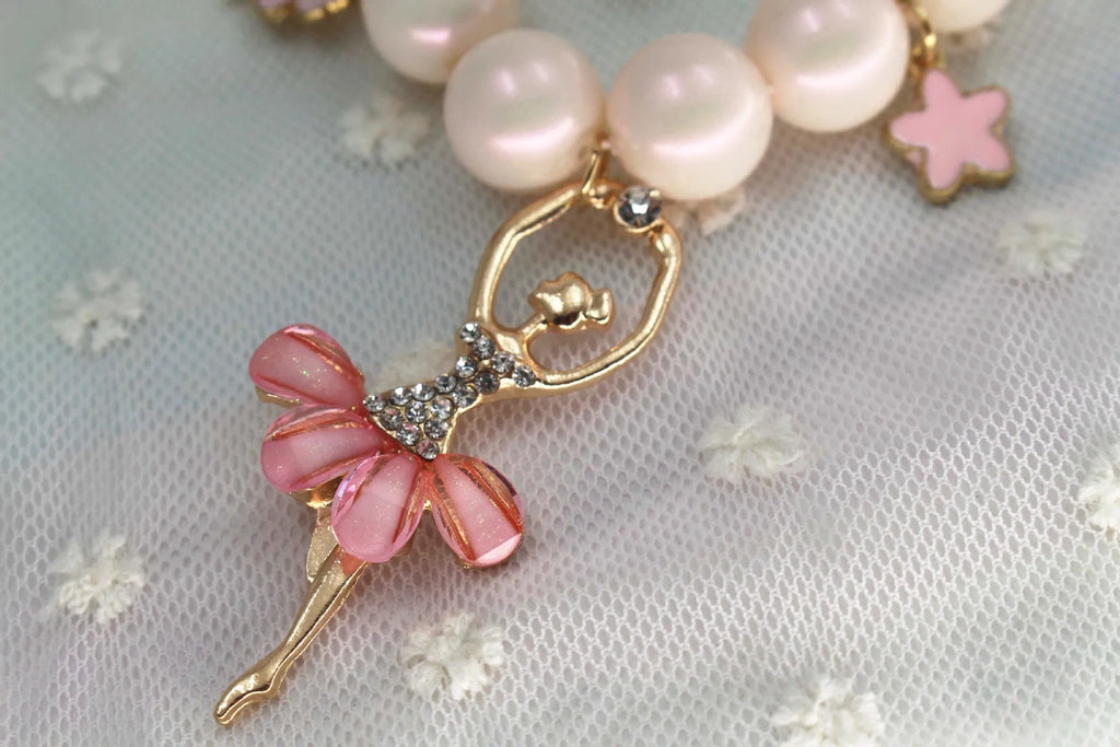 Children's Korean style pearl necklace in Symphony Pink, laid flat on white background