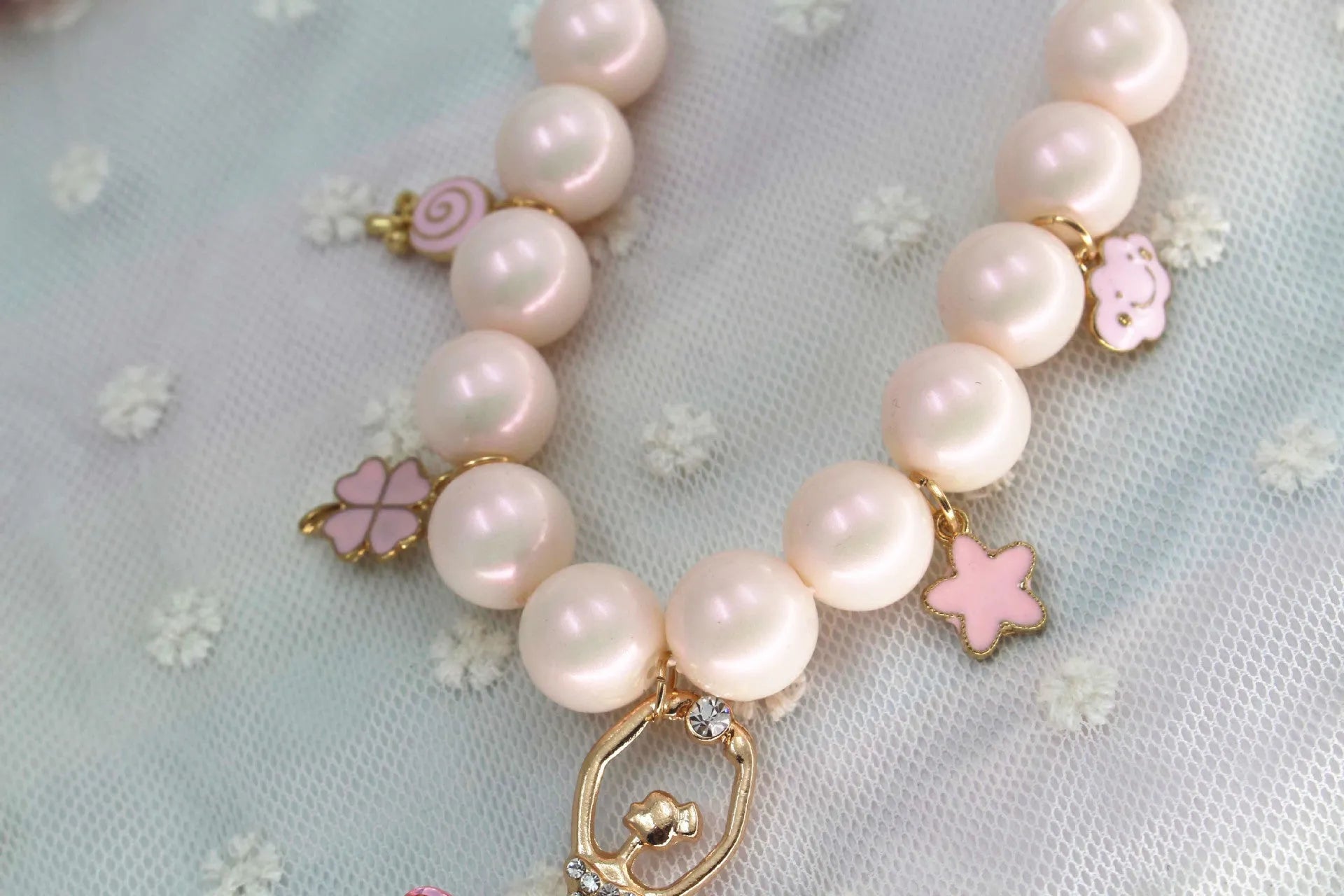 Children's Korean style pearl necklace in Symphony Pink, laid flat on white background