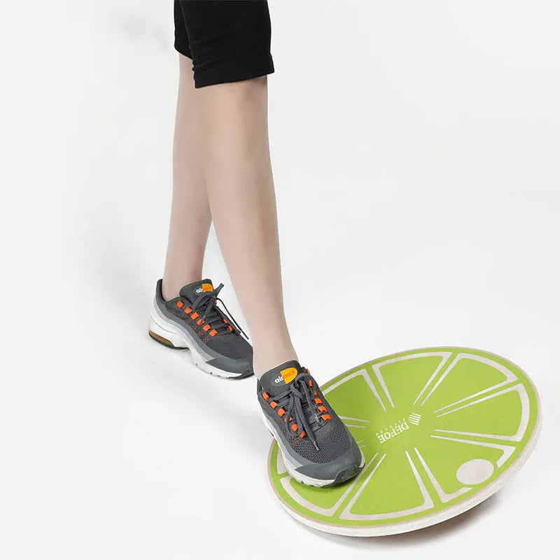 Anti-skid wooden balance board with matte finish, 39.5cm diameter, light green colour, on a gym floor