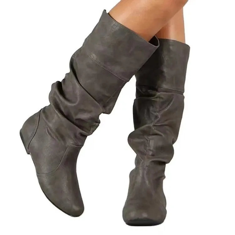 Women's flat-heel slip-on long boots in black with a round toe and high shaft.