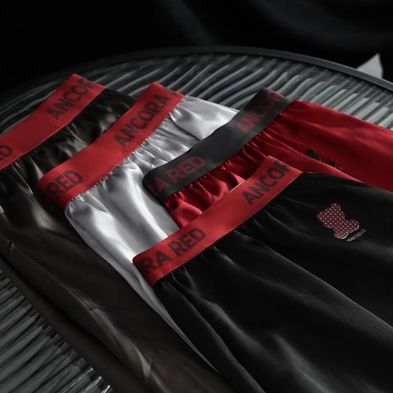 Men's solid colour polyester boxer briefs in black, shown with mid waist design.