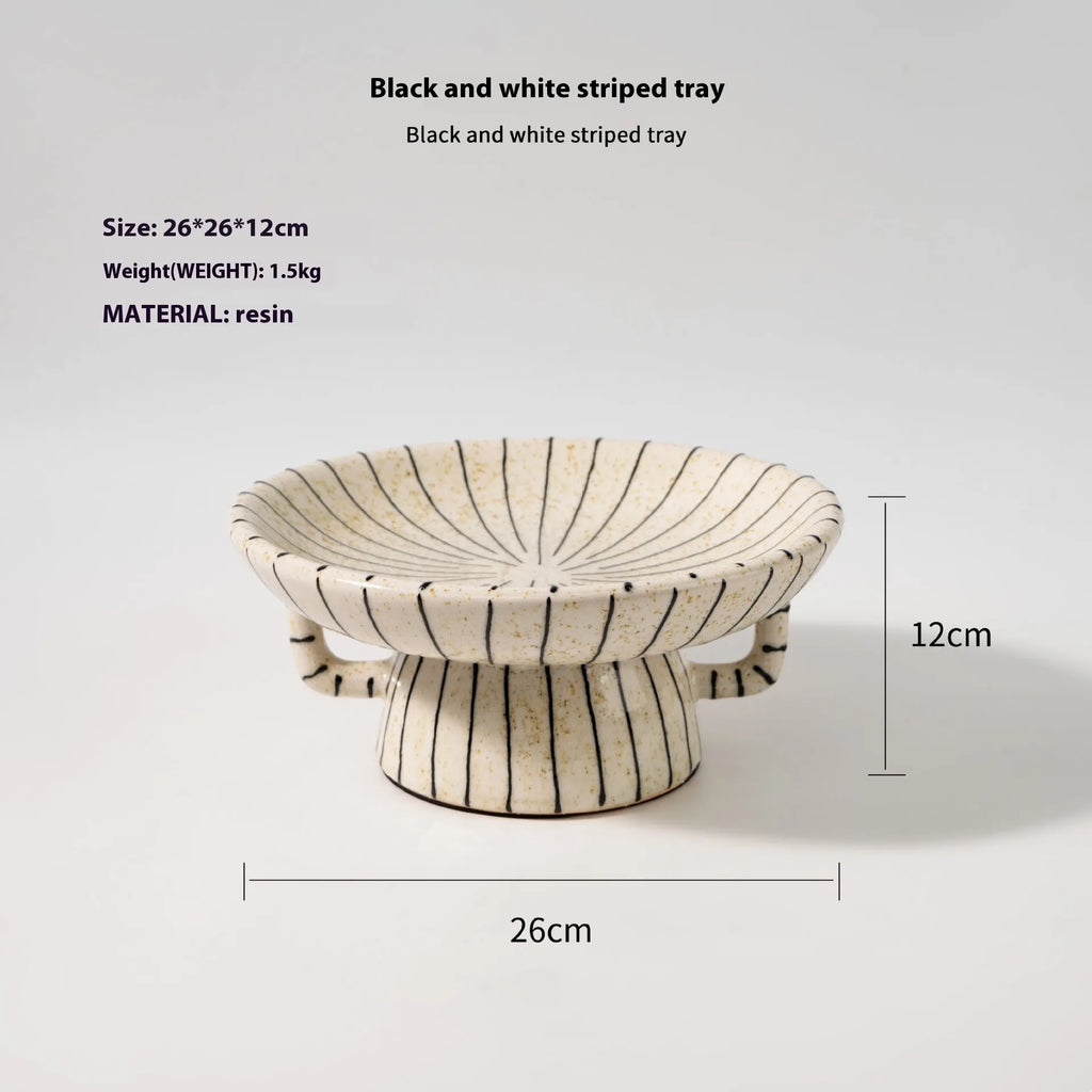 Retro style black and white striped synthetic resin fruit plate on a table.