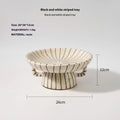 Retro style black and white striped synthetic resin fruit plate on a table.
