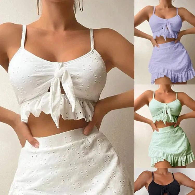 Women's white three-piece bikini set with a split hip skirt, made from polyester.