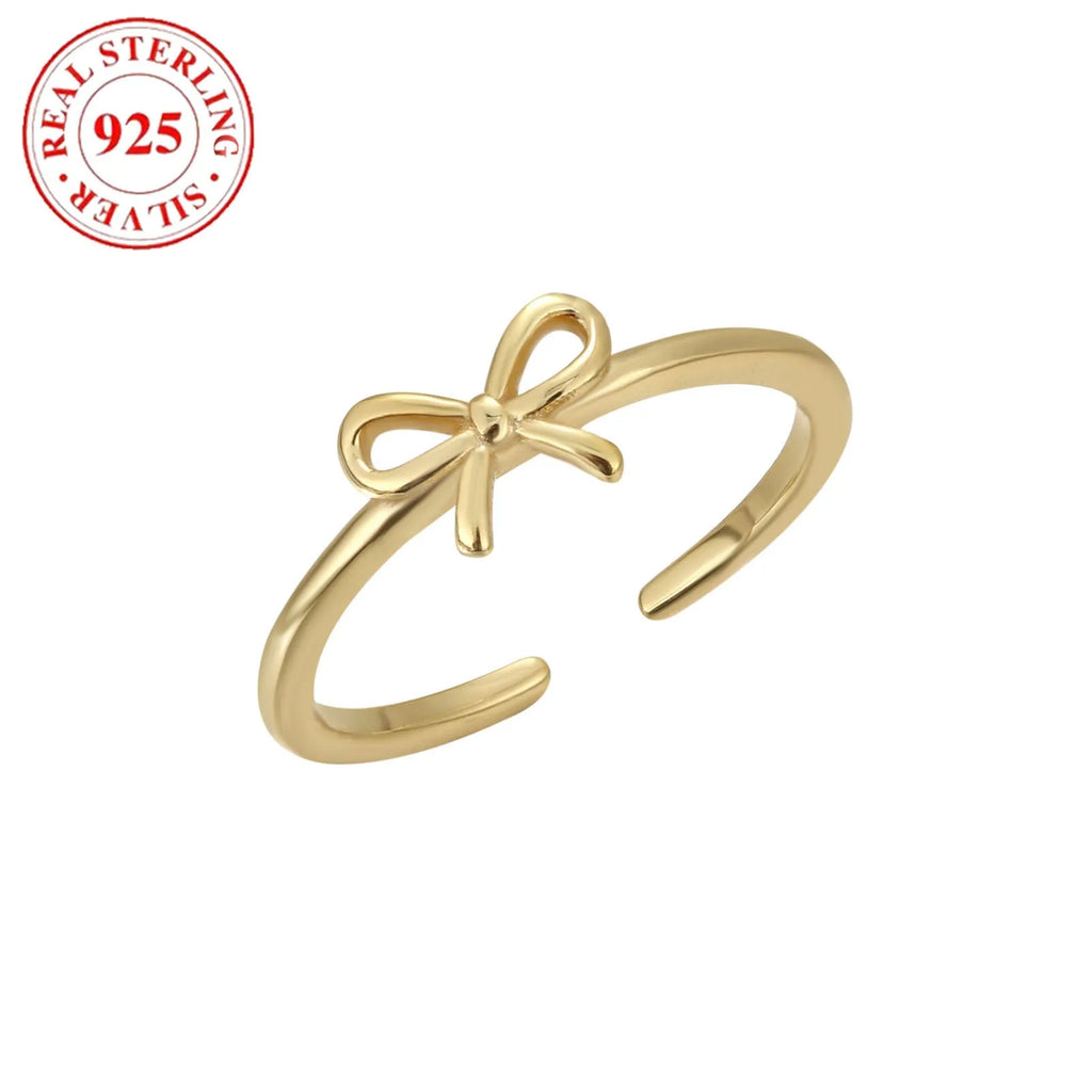 S925 sterling silver bow opening toe ring in gold F026 on a woman's toe