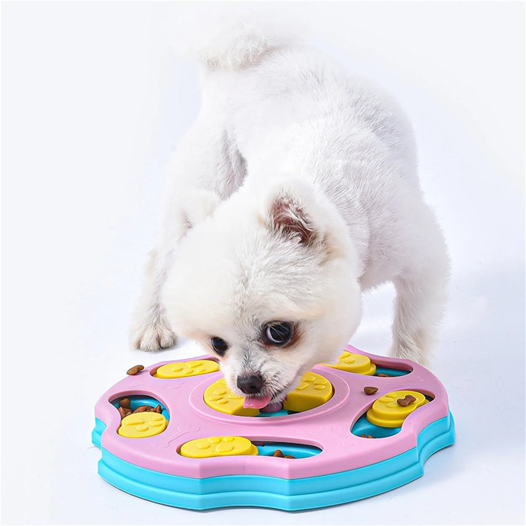 Blue and pink dog puzzle toy feeder bowl for aggressive chewers on a wooden floor.