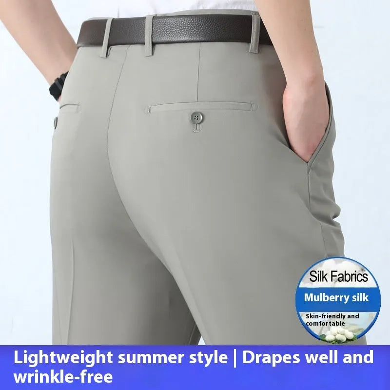 Man wearing dark blue non-iron straight-fit mulberry silk blend business trousers.