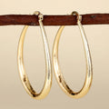 Women's geometric ring design ear clips in copper with electroplated finish showing drop-shaped silhouette