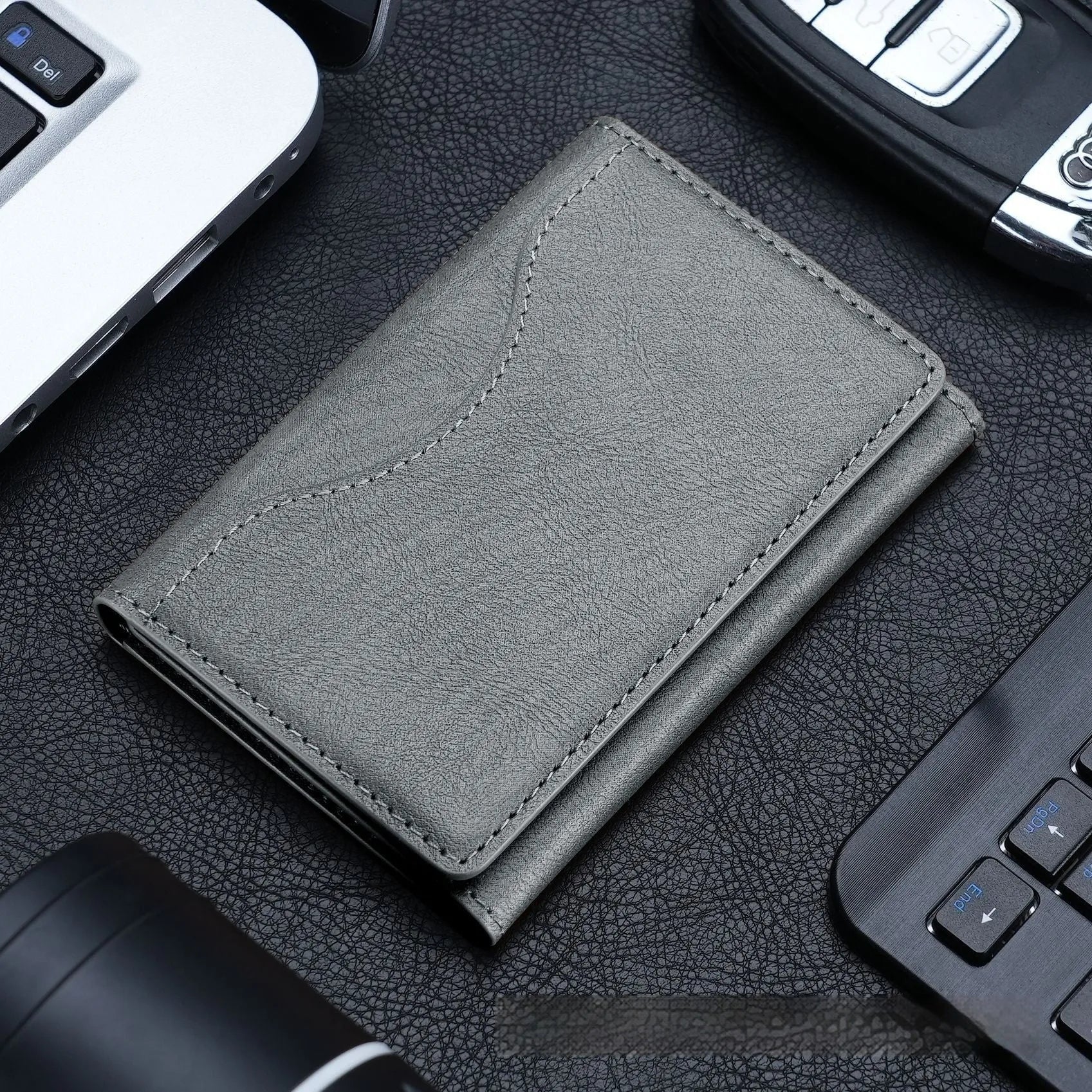 Leather tri-fold magnetic wallet card holder in black with embossed texture