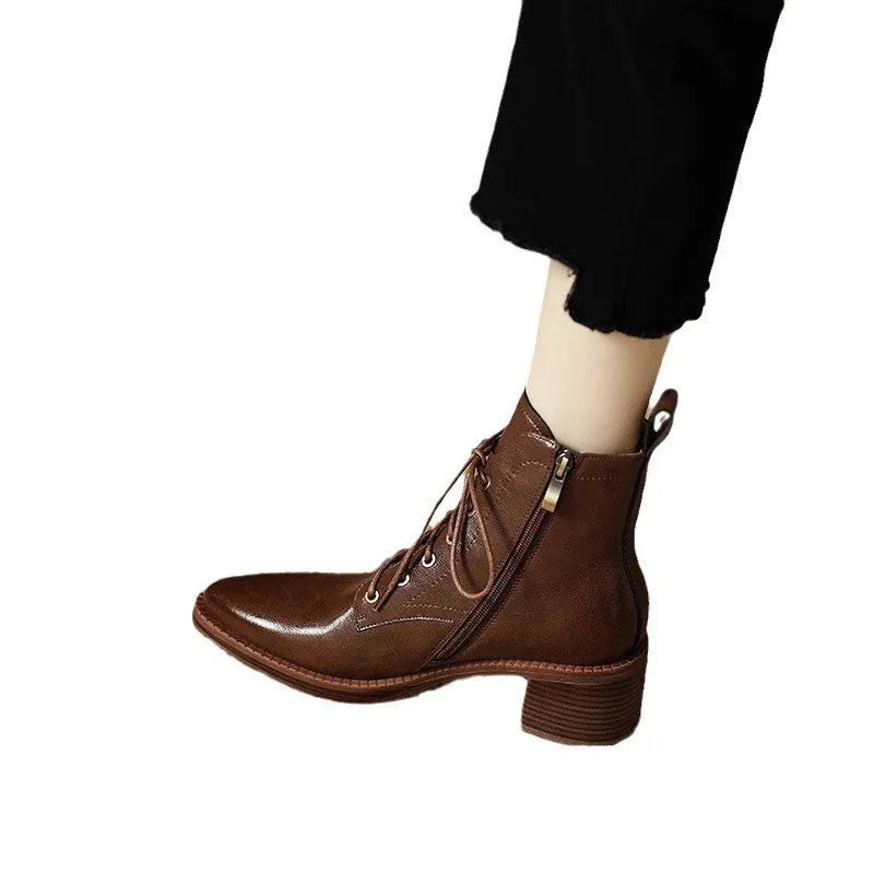 Women's black and brown pointed-toe ankle boots with a 5.5cm heel on a plain background