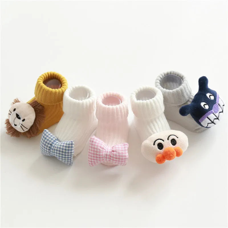 Cotton baby floor socks in assorted colours and patterns including bows, stars, and animal designs.