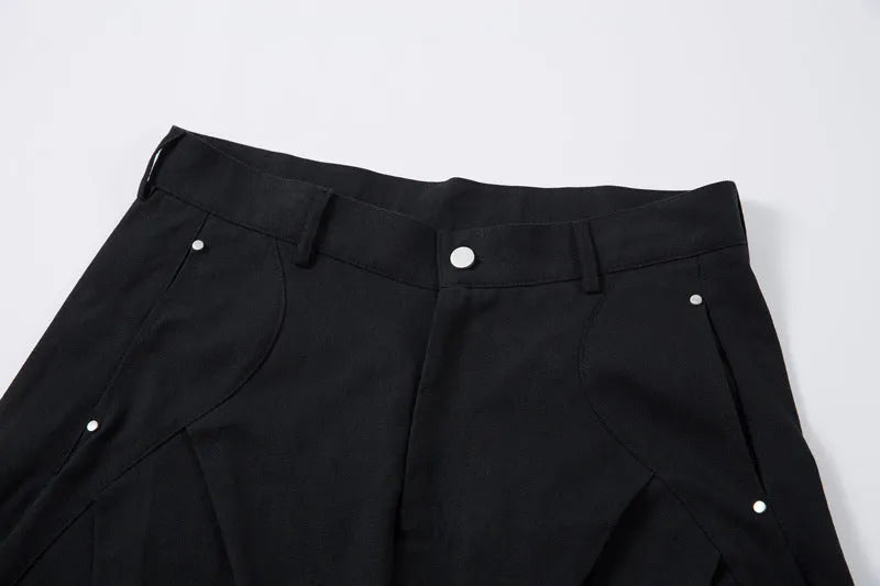 Men's black pleated casual trousers with wide-leg loose fit and machete pleat detailing