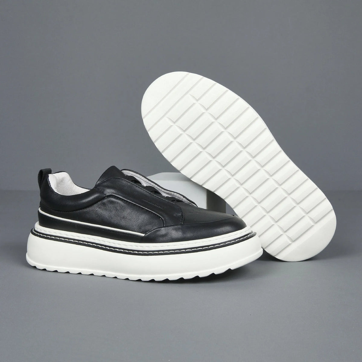 Black breathable first layer cowhide slip-on sneaker with elastic band foam sole low top platform mid heel round toe