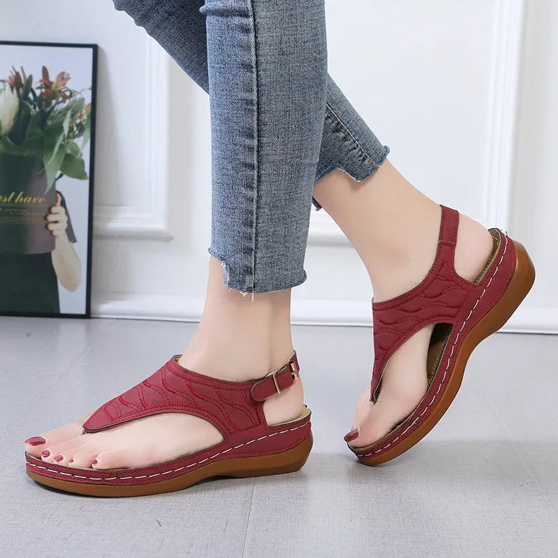 Women's wedge heel sandals with an adjustable buckle strap in a solid colour