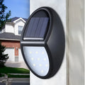 Black solar-powered LED wall light with motion sensor for outdoor security and garden lighting