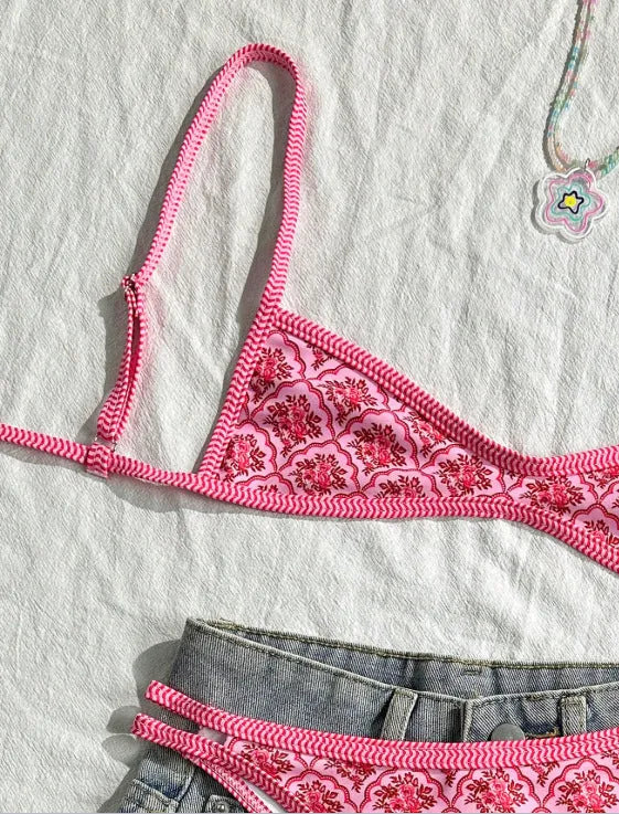 Printed pink split bikini set with exposed back and adjustable shoulder straps on woman