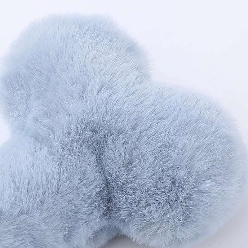 Blue Love Bone shaped plush dog toy with squeaker on a plain background.