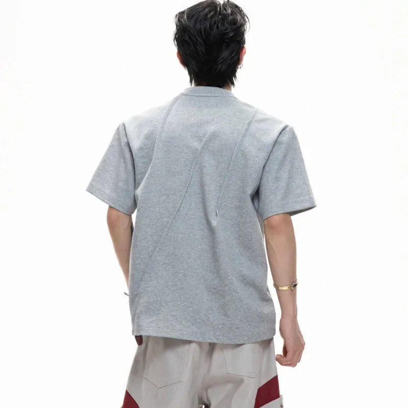 Men's grey loose-fit cotton t-shirt with three-dimensional pleats and a round neck.