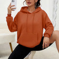 Women's loose grey drawstring pocket sweatshirt with long sleeves on a hanger