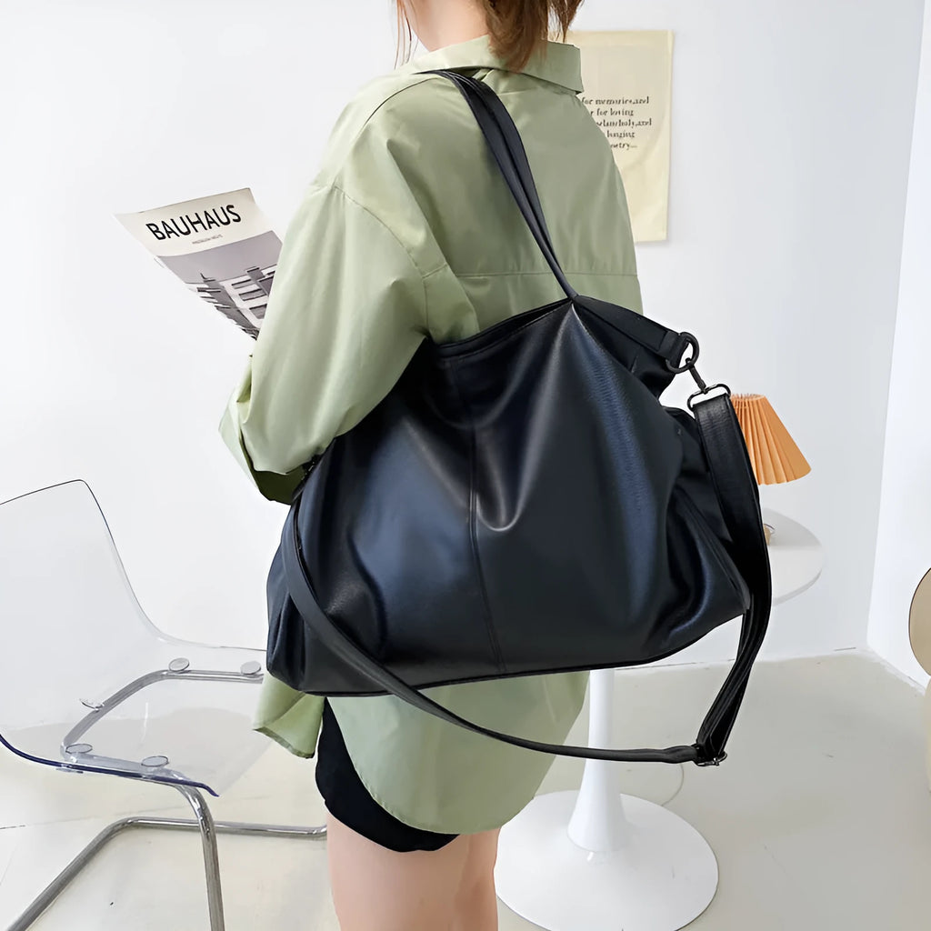 Large horizontal square soft PU messenger bag with zip and adjustable strap in four colour options.