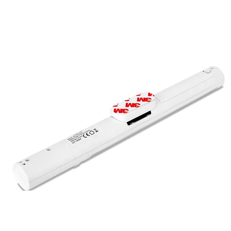 Slim white human body induction LED cabinet light with magnetic base for sticking to metal surfaces.
