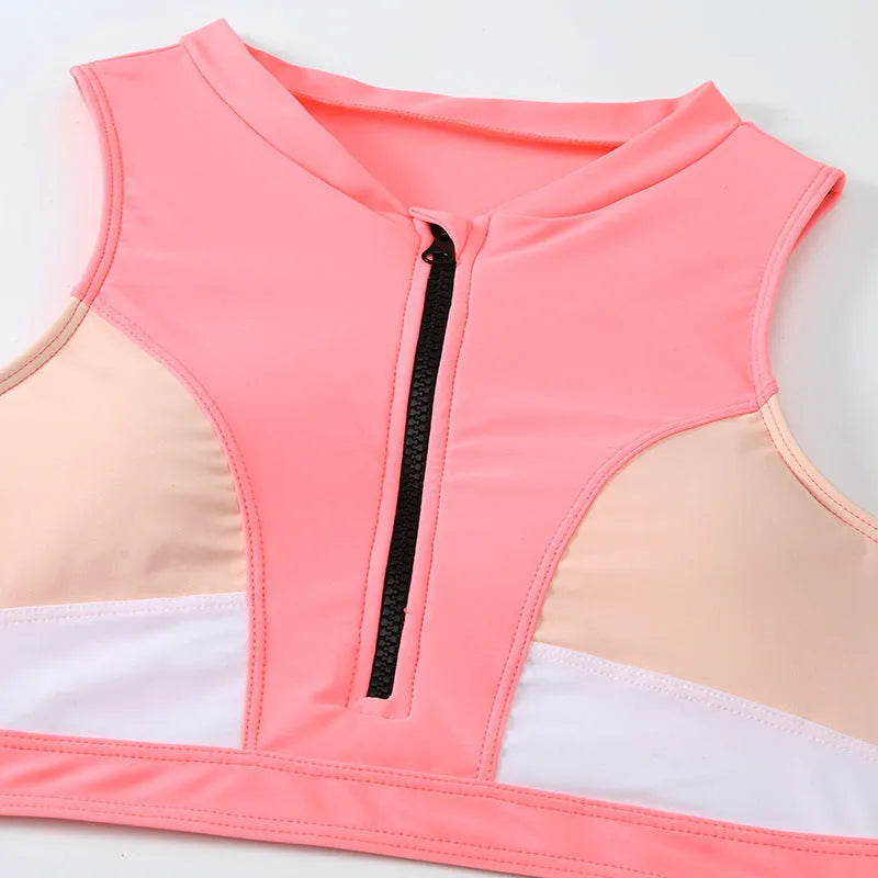 Pink high-waist split leg bikini swimsuit on a hanger, showing brief style and solid colour.