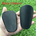 Extra small mini football shin guards in black and white measuring 8cm by 5cm
