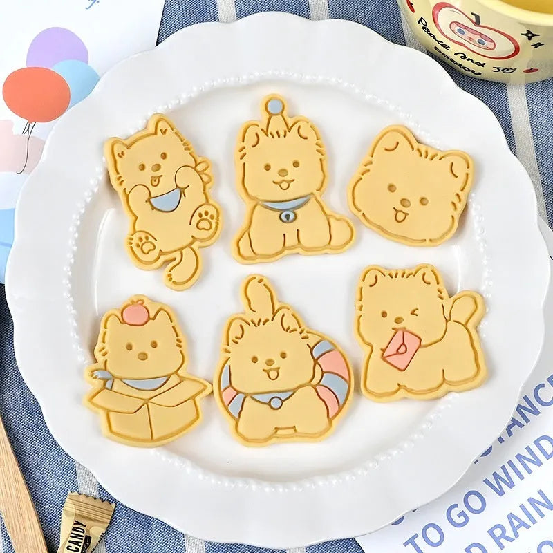 Three dimensional plastic press mould for creating puppy cartoon biscuits and cake decorations.