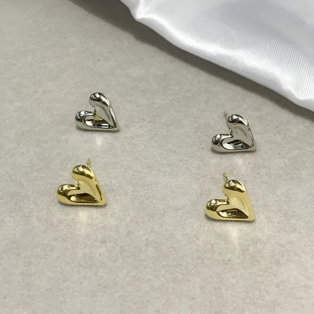 Heart-shaped stud earrings in gold and silvery metal alloy for pierced ears, simple small design