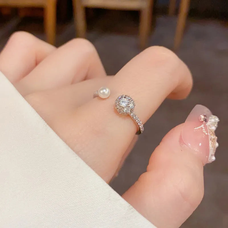 Open-end pearl ring with round zircon stones in geometric design with gold plating