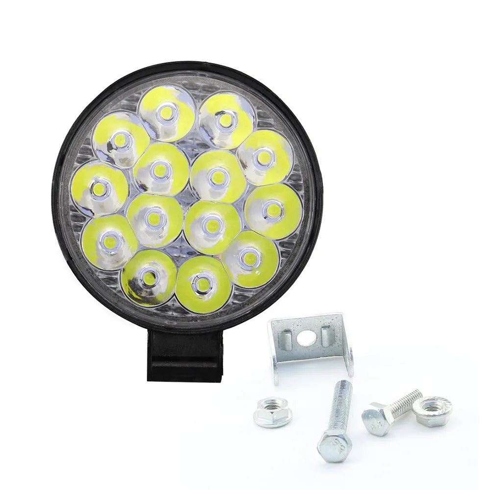 Round mini aluminium LED work light showing white light beam, suitable for vehicle mounting.