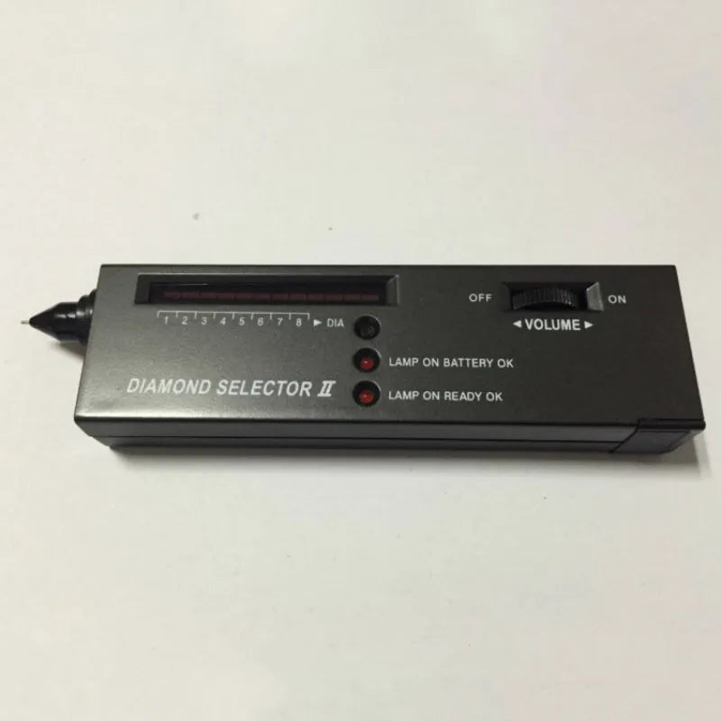 Black handheld Diamond Thermal Conductivity Tester with metal probe on a dark surface.