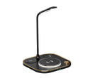 Black wireless charging desk lamp with 15W magnetic pad, Type-C cable, and USB outlet on a wooden desk.