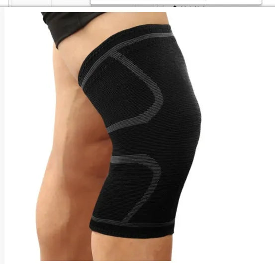 Close-up of a black double corrugated stretch knee pad for sports on a gym floor.