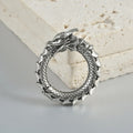 Large geometric dragon earrings with antique silver finish and hollow-out design on white background