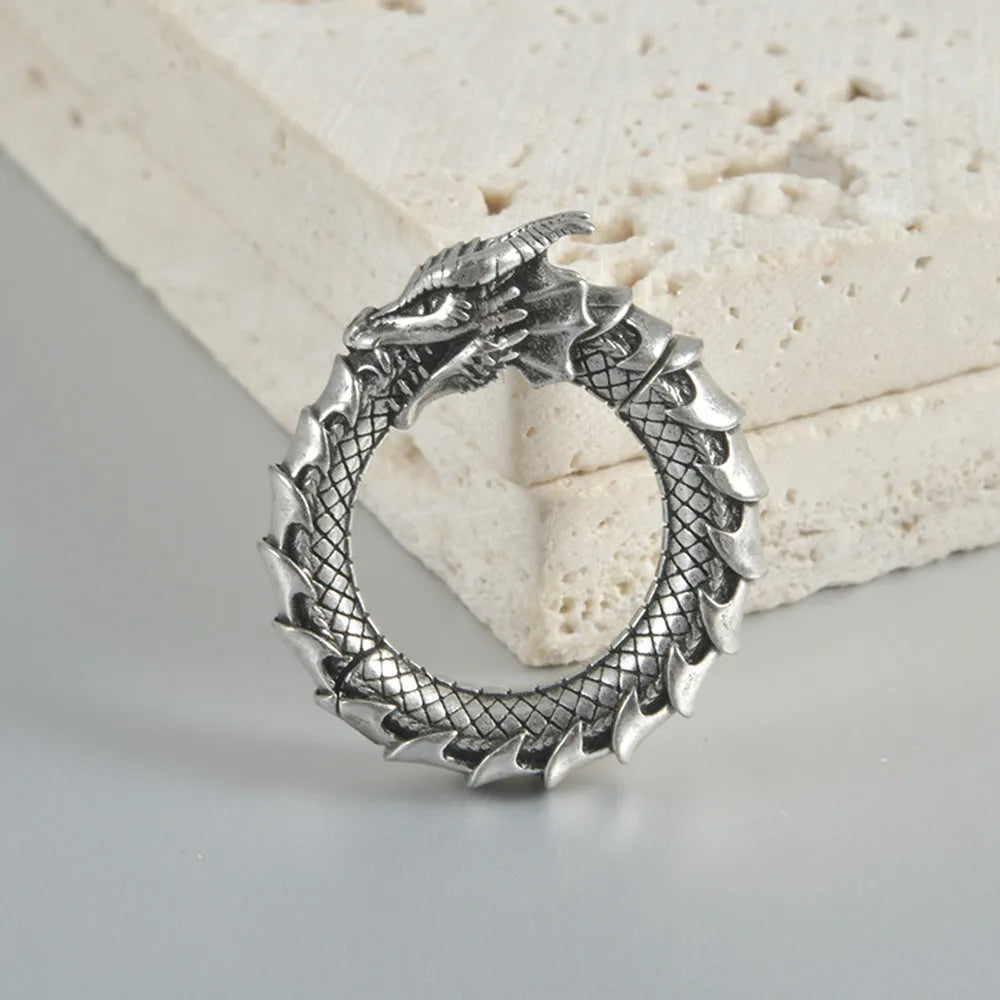 Large geometric dragon earrings with antique silver finish and hollow-out design on white background