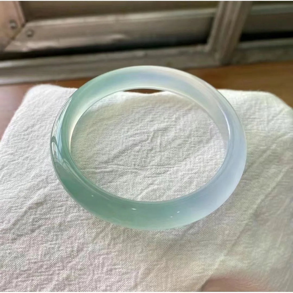 Natural agate wide tyre bracelet shown in multiple colour options on a wrist, demonstrating its substantial band width.