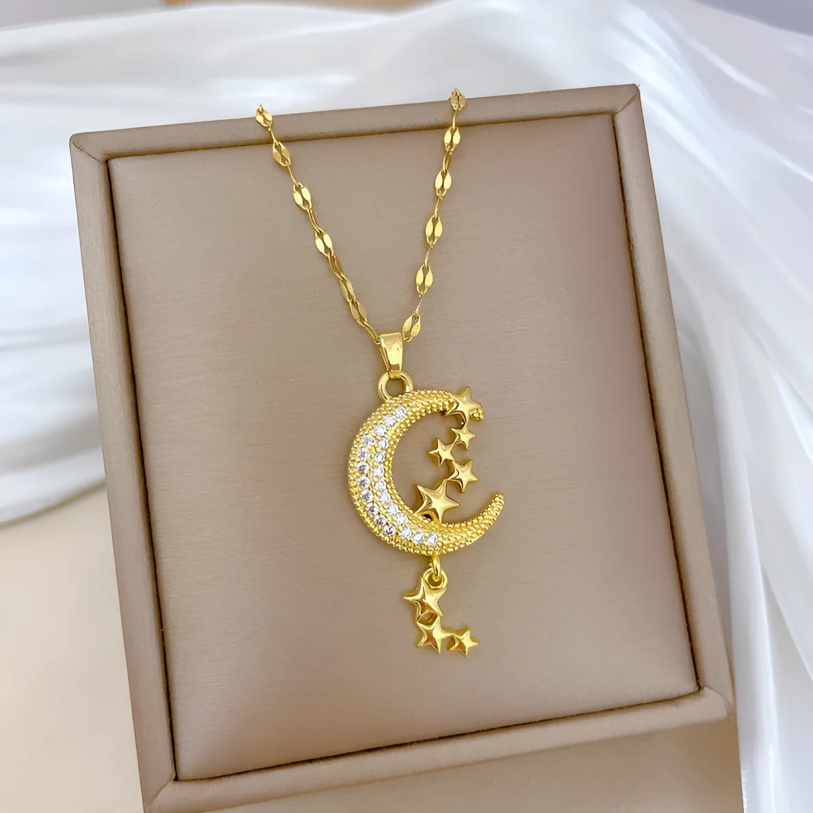 Moon tassel necklace with geometric design and diamond elements on stainless steel chain