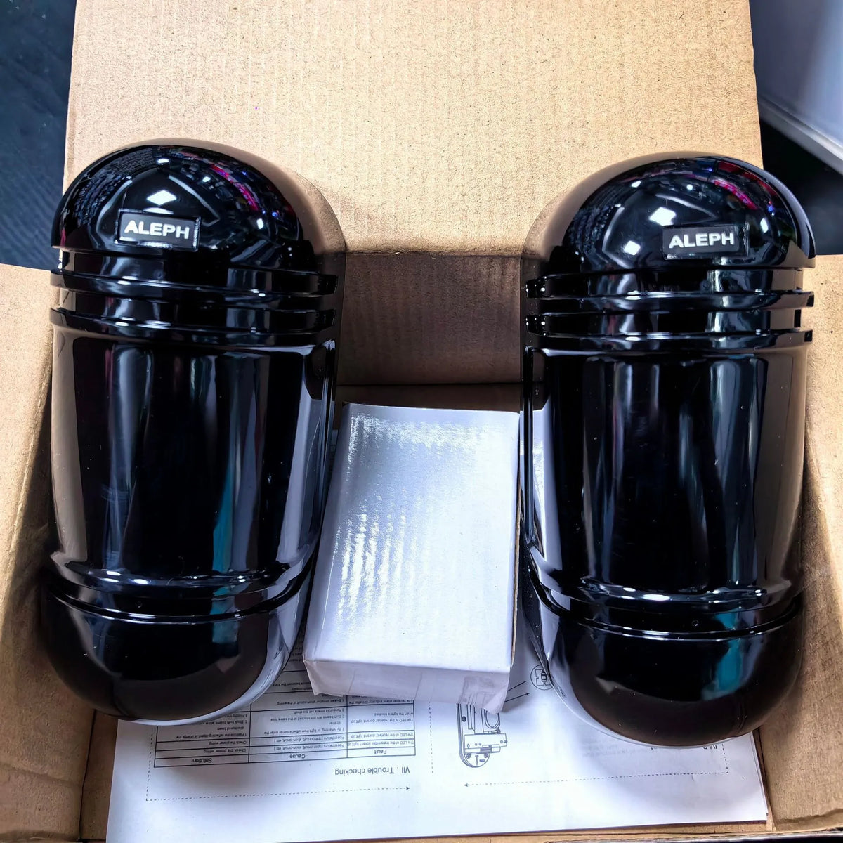A pair of black infrared detector units for a wired anti-theft alarm system with a 150-metre range.
