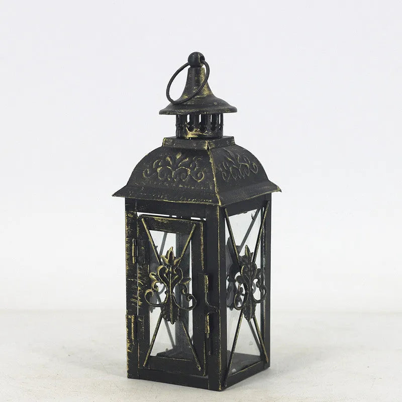 Black and white wrought iron floor-standing storm lantern with tempered glass panels in three sizes for courtyards.