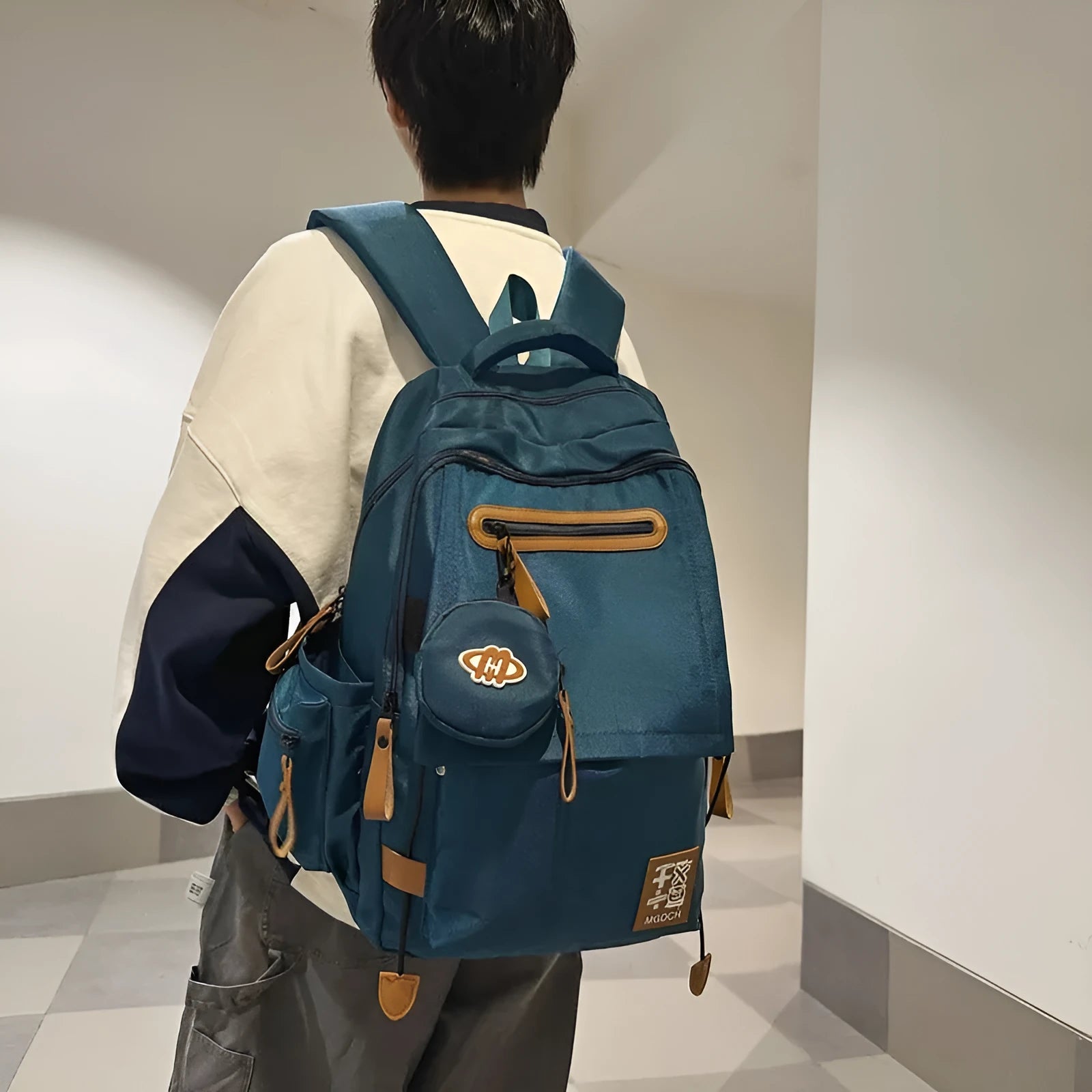 Street style large capacity nylon backpack for middle school students in solid colour with curved shoulder straps.