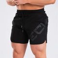 Men's black knee-length training shorts with an elastic waistband, made from quick-dry nylon blend fabric.