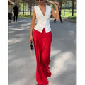 Women's beige two-piece set with deep V-neck sleeveless top and wide-leg trousers