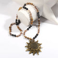 Natural stone beaded necklace with ancient cyan sun pendant and glass knotted chain in black or dark brown.