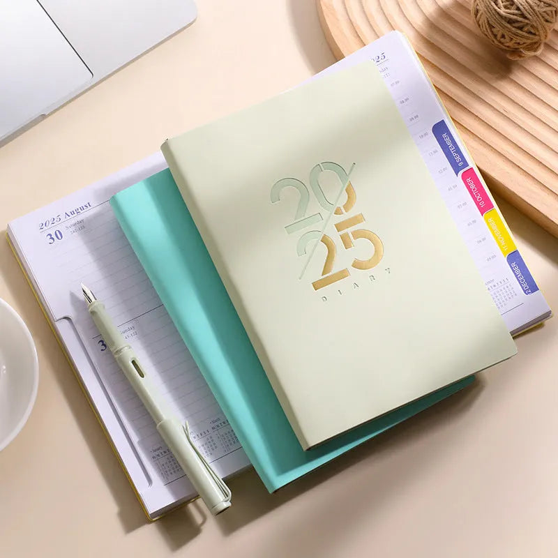 A5 soft faux leather 2025 daily planner book open on a desk, showing weekly schedule pages.