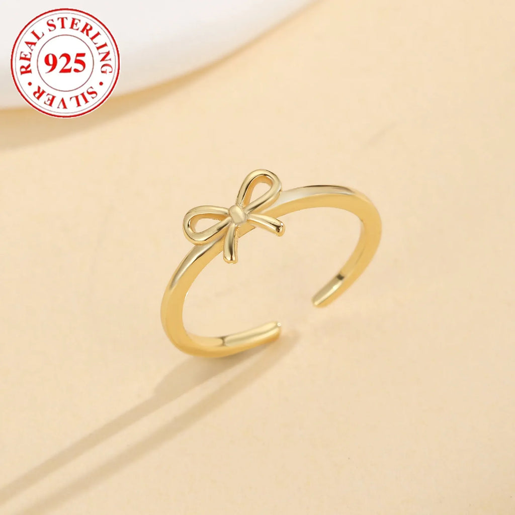 S925 sterling silver bow opening toe ring in gold F026 on a woman's toe